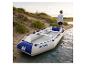 Bateau gonflable HOME DELUXE Pike Eco sur une plage de sable au bord de l'eau.