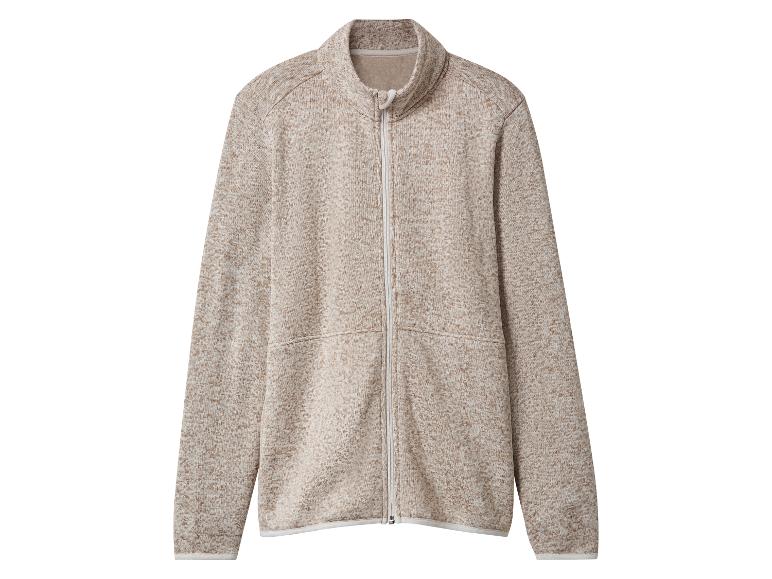 Veste polaire beige avec fermeture éclair, poches latérales et col montant.