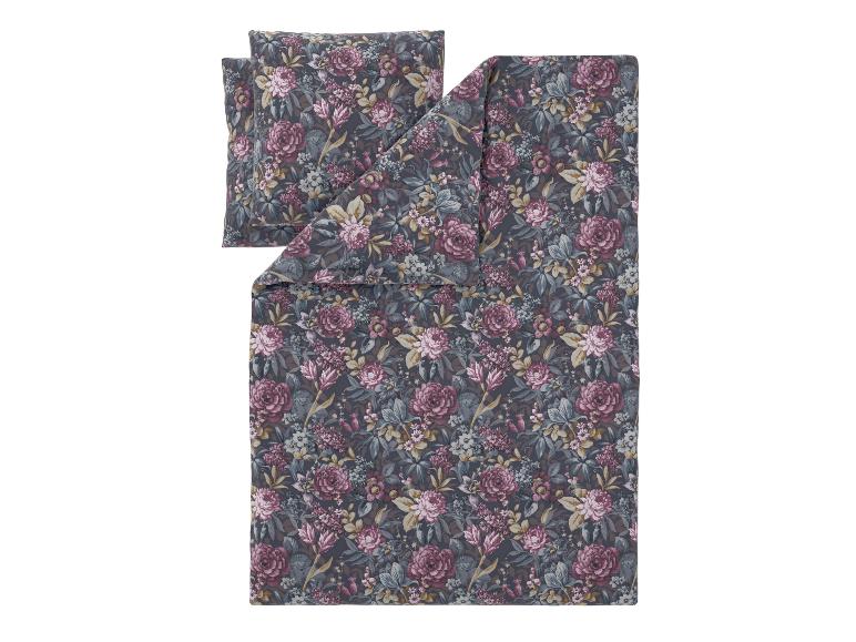 Parure de lit florale avec housse de couette et taie d'oreiller sur fond gris foncé.