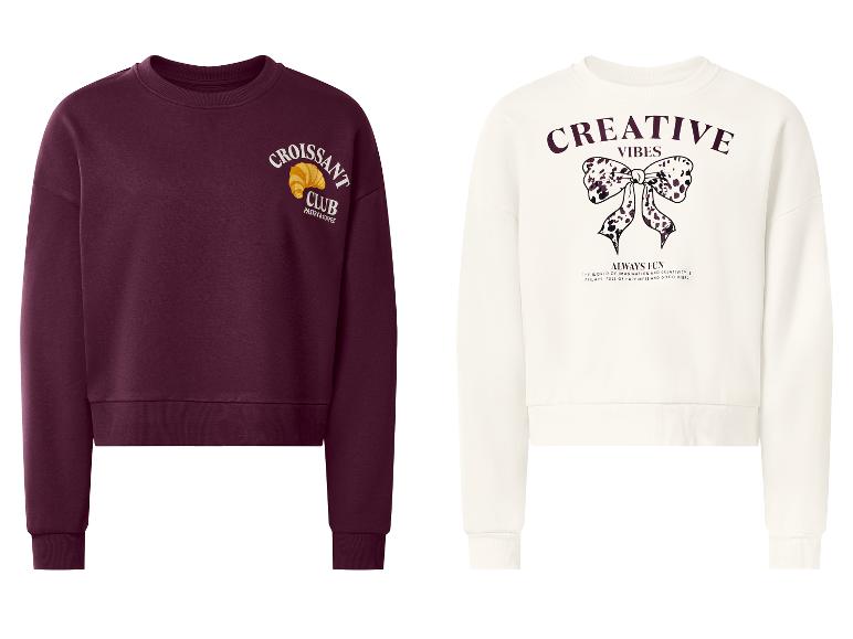 Deux sweatshirts : un bordeaux avec « Croissant Club » et un blanc avec « Creative Vibes ».