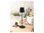 Lampe noire design sur table en bois, ambiance détente.