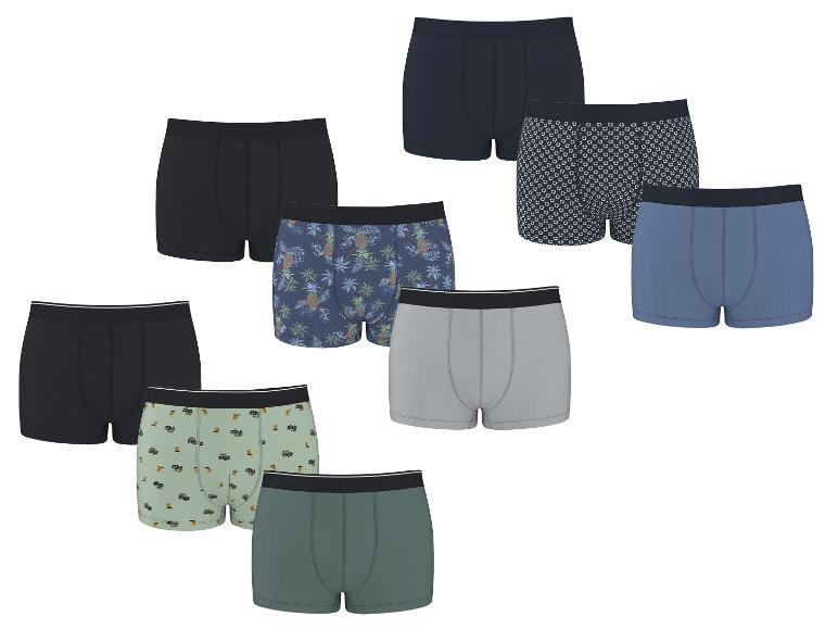 Un assortiment de boxers en coton de différentes couleurs et motifs, y compris des ananas et des voitures.