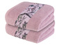Deux serviettes roses avec un motif floral.