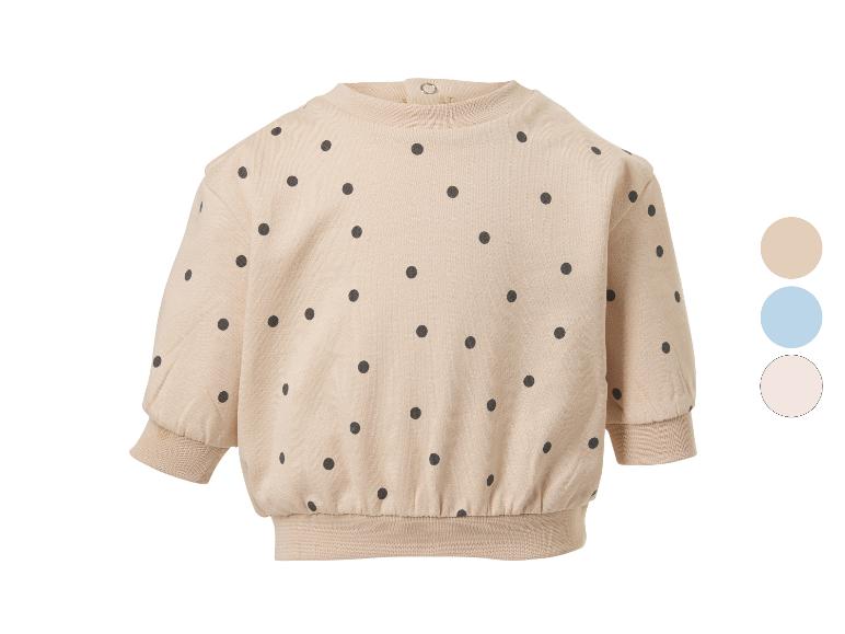 Sweat-shirt bébé beige à pois noirs avec trois options de couleur.