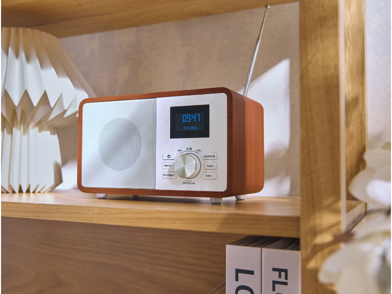 Radio en bois de style rétro sur une étagère avec l'heure affichée.