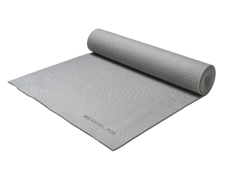 Tapis de yoga ou d'exercice gris, partiellement roulé, avec une surface texturée.