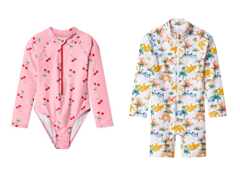 Deux maillots de bain à manches longues pour enfants : un rose à cerises et un blanc à dinosaures.