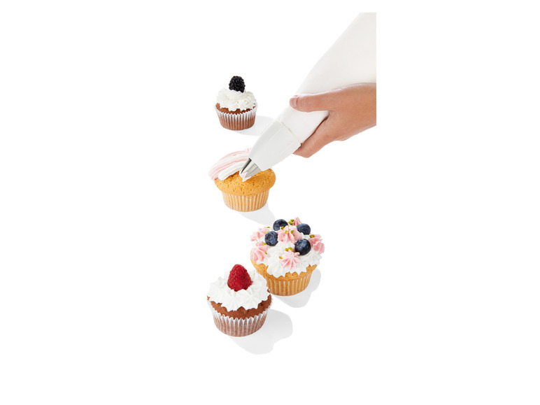 Des cupcakes avec différentes garnitures sont décorés à l'aide d'une poche à douille.