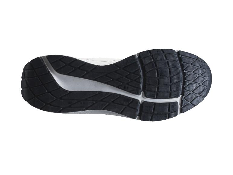 Dessous d'une semelle de chaussure de course noire et blanche avec un motif texturé.