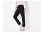 Pantalon de jogging noir femme avec cordon de serrage et sweat-shirt blanc.