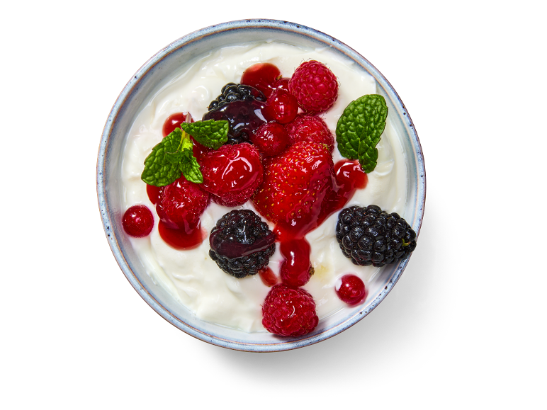 Yaourt aux fruits des bois et menthe dans un bol.