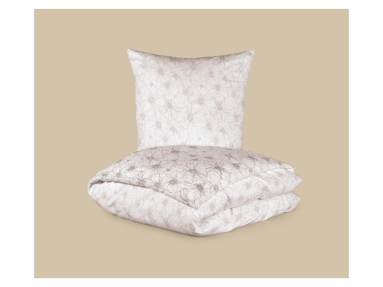 Parure de lit blanche avec motif floral beige.
