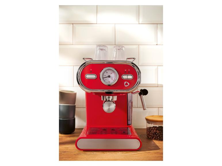 Machine à expresso rouge sur un comptoir de cuisine avec tasses et grains de café.
