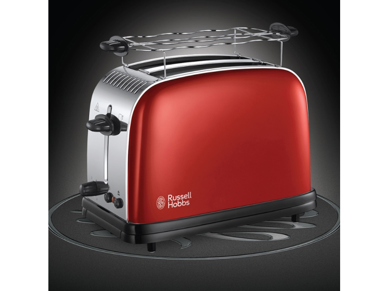 Grille-pain rouge avec des détails chromés et une grille pour réchauffer les petits pains.