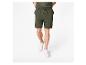 Homme en baskets blanches et short de sport vert olive.