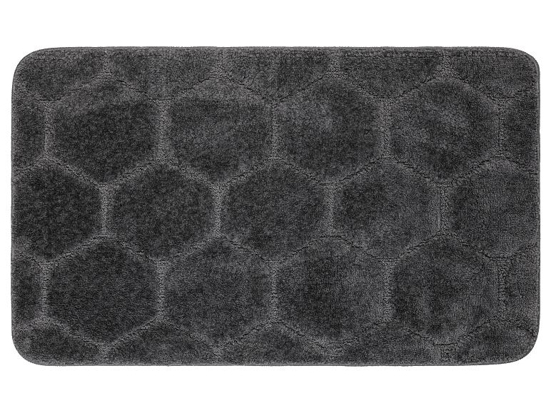 Un tapis de bain gris avec un motif en nid d'abeille.