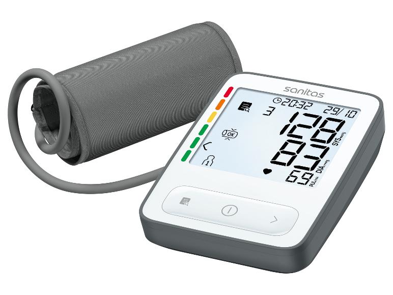 Tensiomètre numérique Sanitas avec brassard gris et grand écran, affichant 128/87 et 69 bpm.