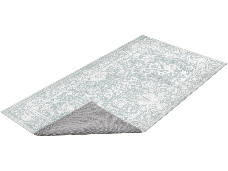 Tapis rectangulaire à motif floral dans des tons vert menthe et blanc, avec le dos antidérapant visible.