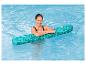 Femme en maillot de bain se relaxant dans une piscine avec une frite de piscine verte.