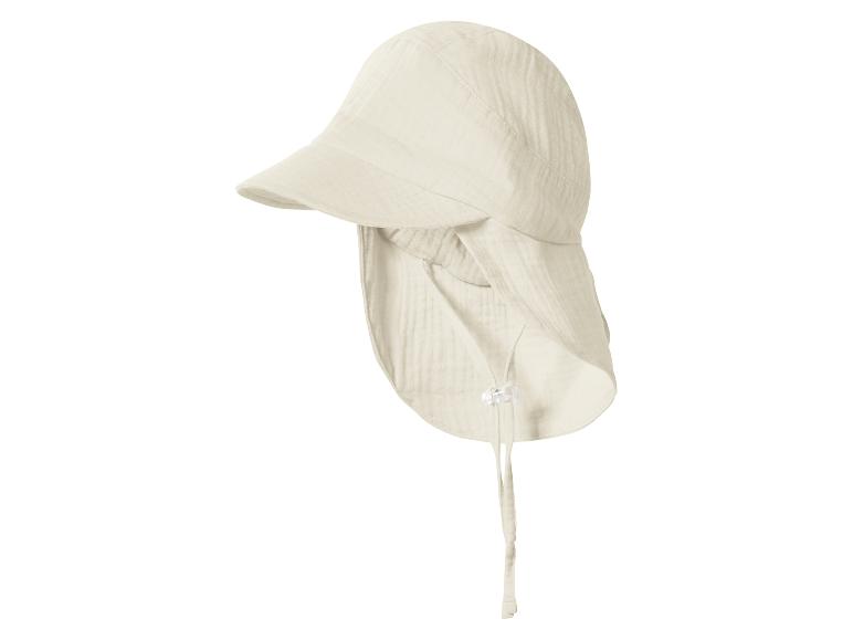 Chapeau de soleil beige clair avec protège-nuque et liens sous le menton, en tissu froissé.