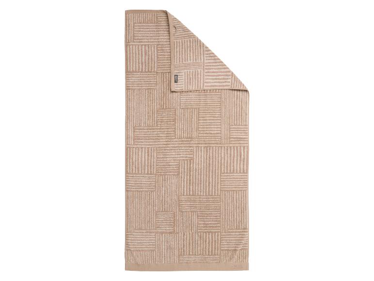 Serviette beige avec un motif géométrique de rayures horizontales et verticales.