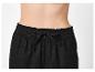 Pantalon noir pour femme avec taille élastique et cordon de serrage.