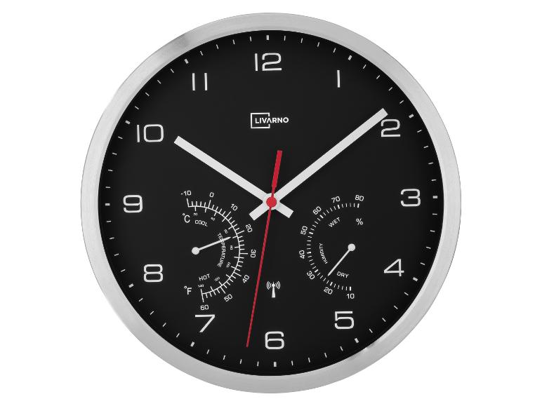 Horloge murale Livarno avec thermomètre et hygromètre, cadran noir et cadre argenté.