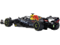 Voiture de course Formule 1 miniature noire et jaune avec pneus de course.
