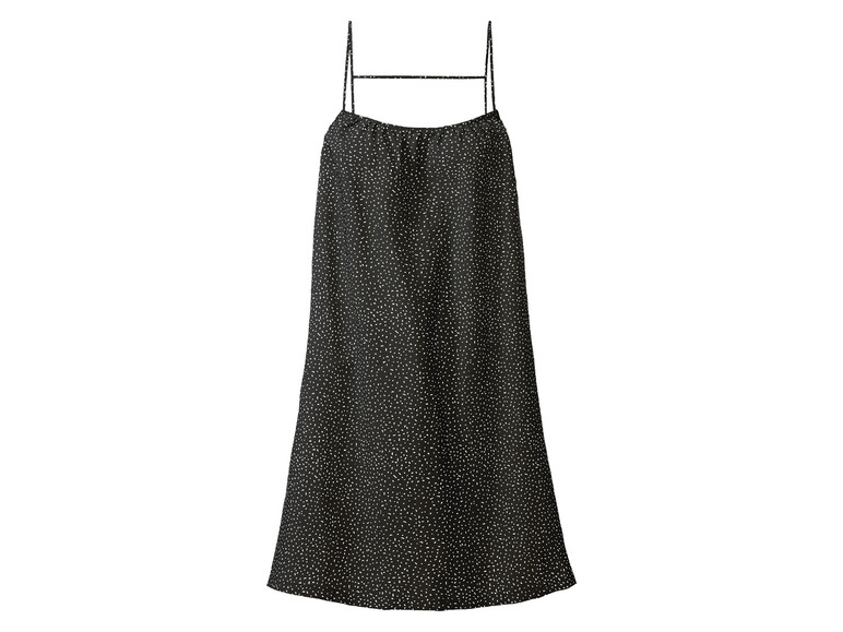 Une robe noire à bretelles fines avec des pois blancs.