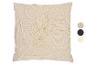 Coussin beige avec motif de feuilles touffues et palette de couleurs.