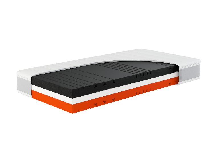 Vue en coupe d'un matelas, révélant ses couches intérieures blanches, noires et oranges.