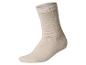 Une chaussette beige unie sur fond blanc.