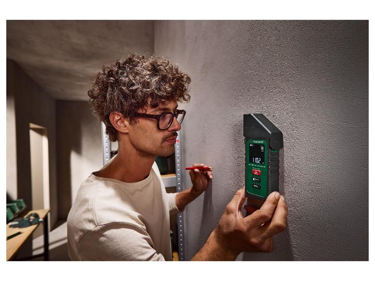 Homme avec télémètre laser PARKSIDE 1102 m marquant un mur.