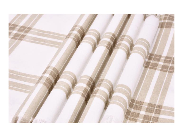 Tissu à carreaux blanc et beige plié en rangées