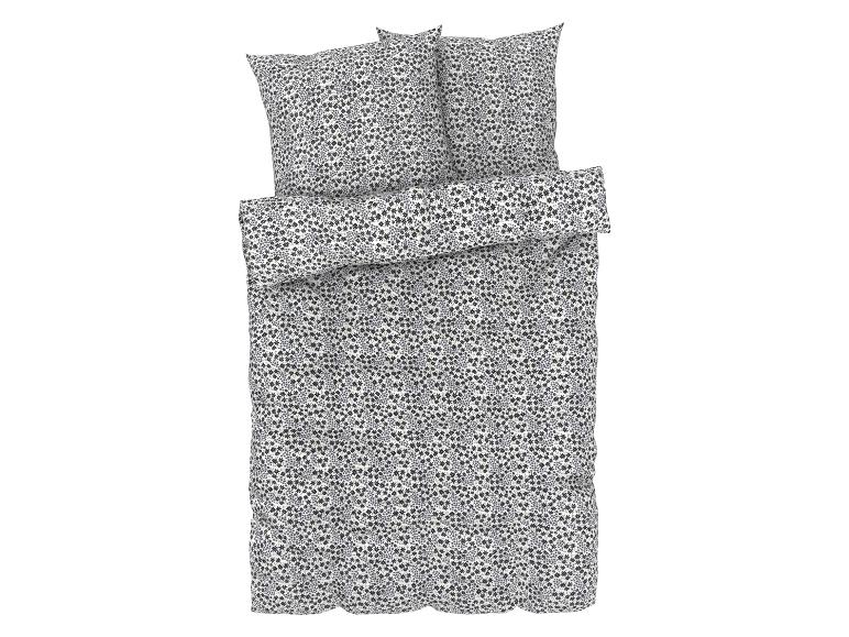 Une housse de couette blanche avec un motif floral noir, comprenant deux taies d'oreiller.