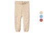 Pantalon tricoté pour bébé en beige avec options de couleur bleue et rouge.