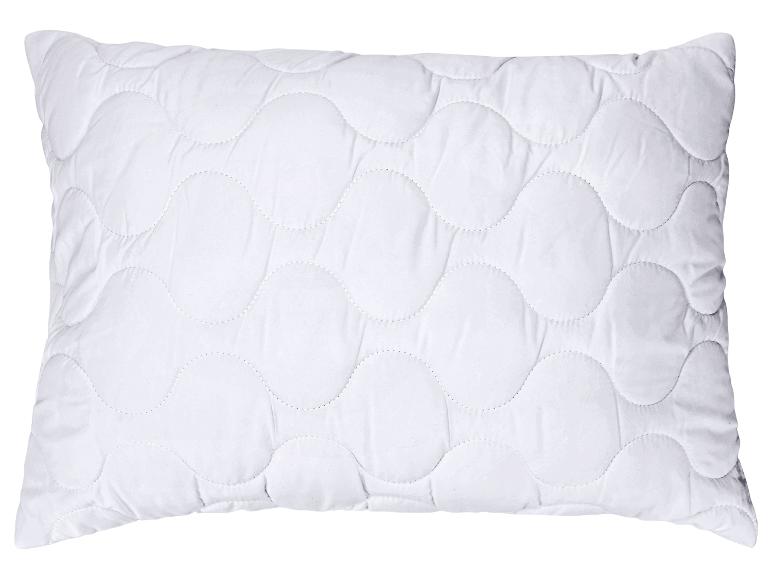 Oreiller blanc matelassé avec un motif ondulé