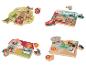 Quatre puzzles en bois avec différents thèmes : forêt, transport, ferme et jungle.