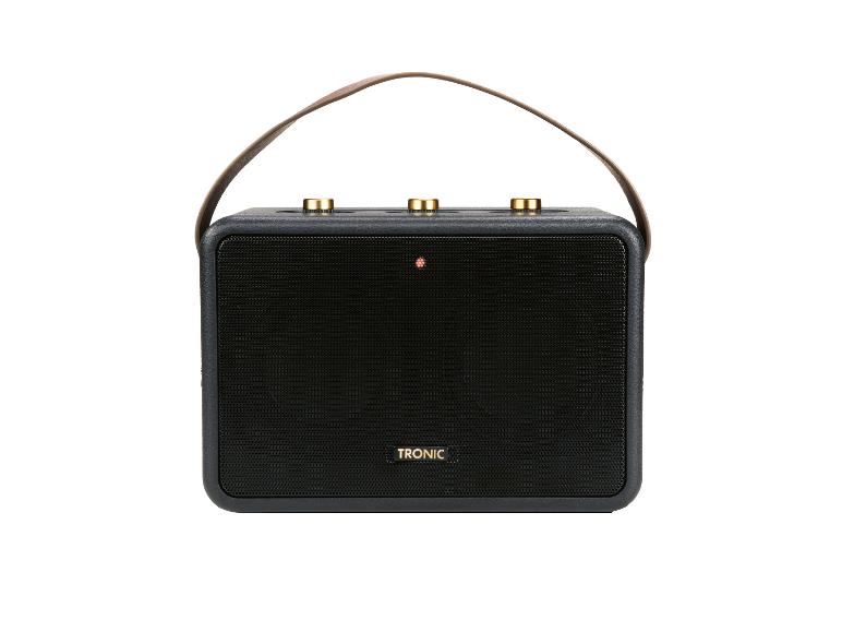 Enceinte portable noire avec une sangle en cuir marron et des boutons dorés.