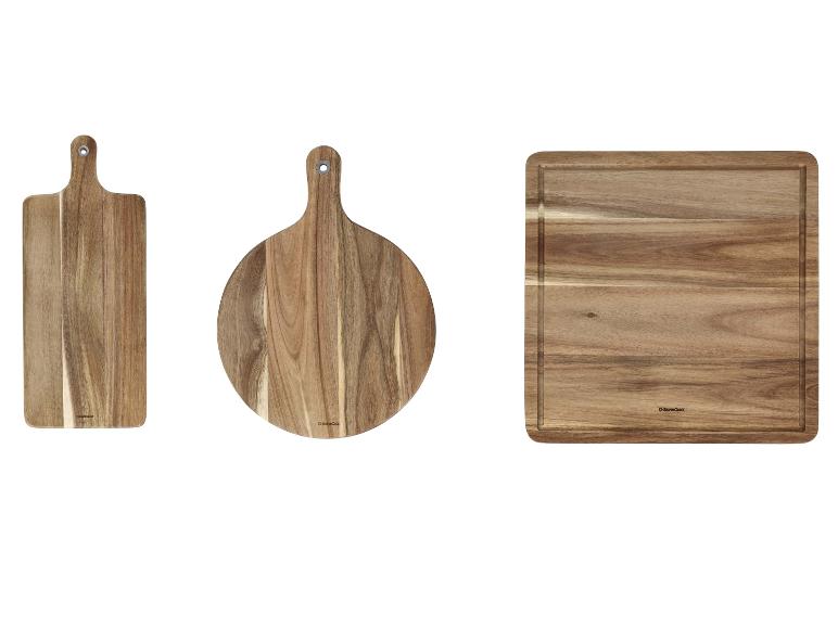 Trois planches à découper en bois : rectangulaire avec poignée, ronde avec poignée et carrée.