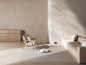 Robot aspirateur blanc nettoyant un salon moderne et minimaliste.