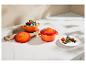 Mini cocottes en céramique orange avec un dessert au chocolat et des baies.