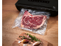 Bœuf emballé sous vide avec une machine de scellage sous vide et des herbes fraîches.