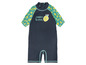 Un maillot de bain bleu foncé à manches courtes avec un motif de citron.