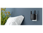 Un répéteur WiFi Xiaomi noir avec des antennes, branché sur une prise de courant.