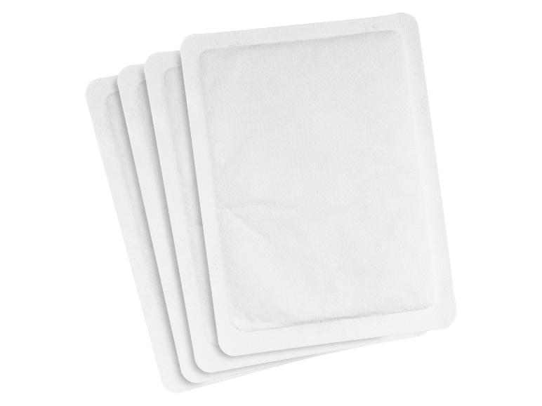 Quatre patchs chauffants rectangulaires blancs empilés les uns sur les autres