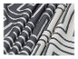 Tissu à motif abstrait blanc et gris.