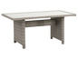 Une table de jardin en osier gris avec un plateau blanc.