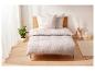 Housse de couette beige avec motif abstrait sur un lit