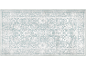 Tapis rectangulaire avec motif floral abstrait et bordure décorative, dans des tons bleus et blancs.